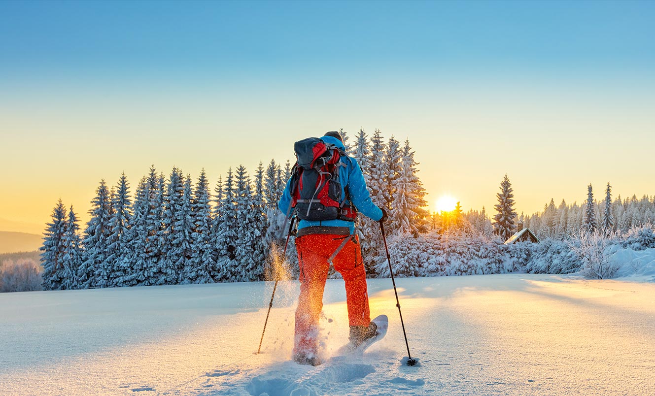 person snow skiing at sunset