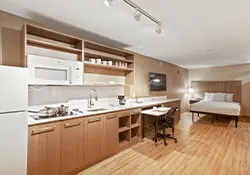 hotel room with fully equipped kitchen and workspace